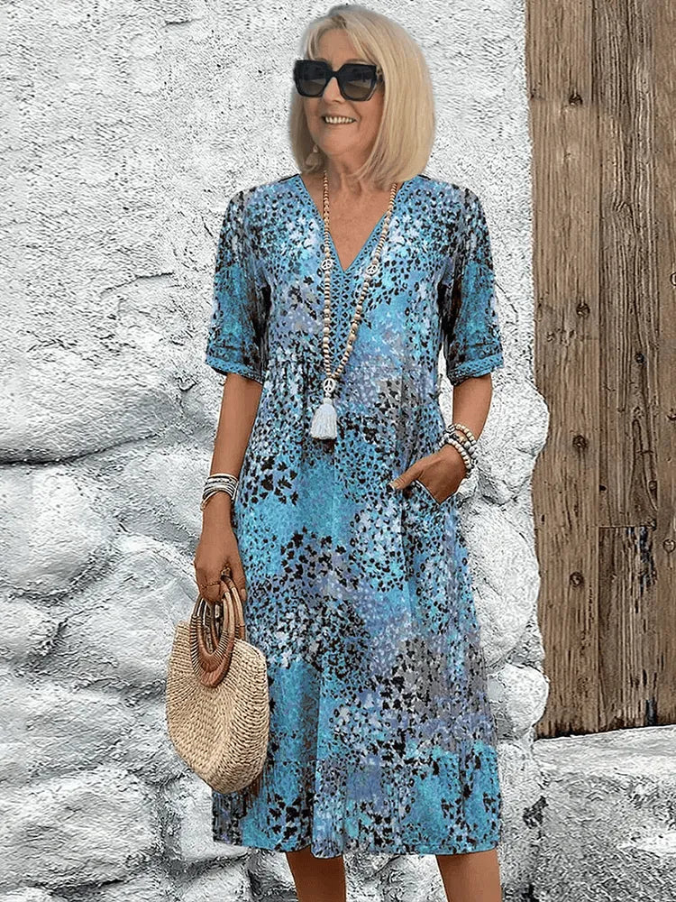 Homixa Sienna women's printed midi dress featuring a vibrant floral pattern and flowing silhouette.