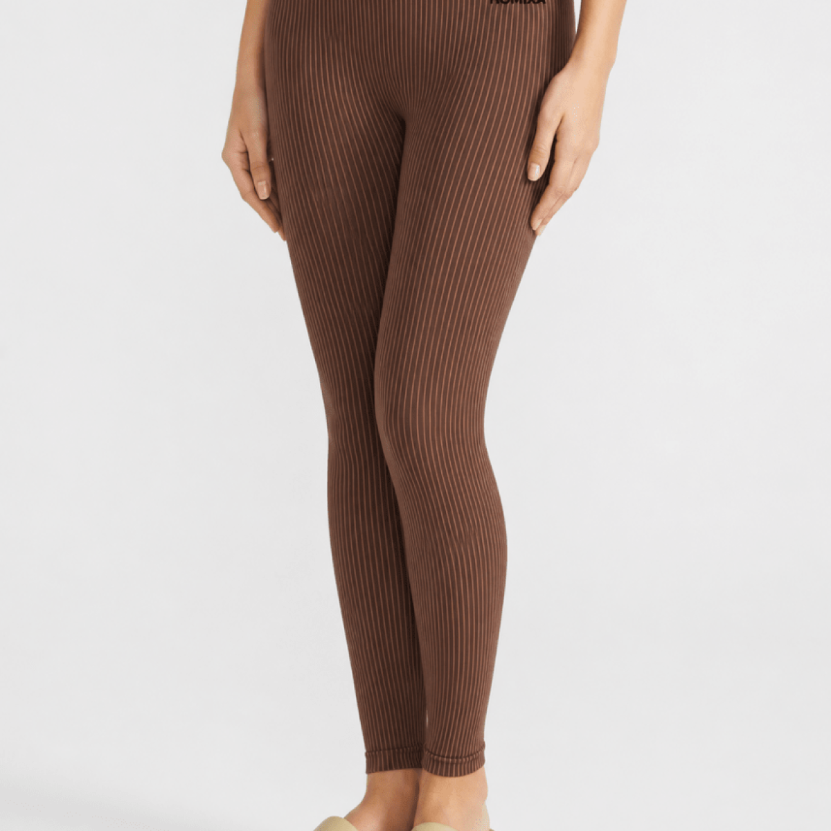 Homixa ribbed core seamless women's brown leggings displayed, showing the textured ribbed design and snug fit.