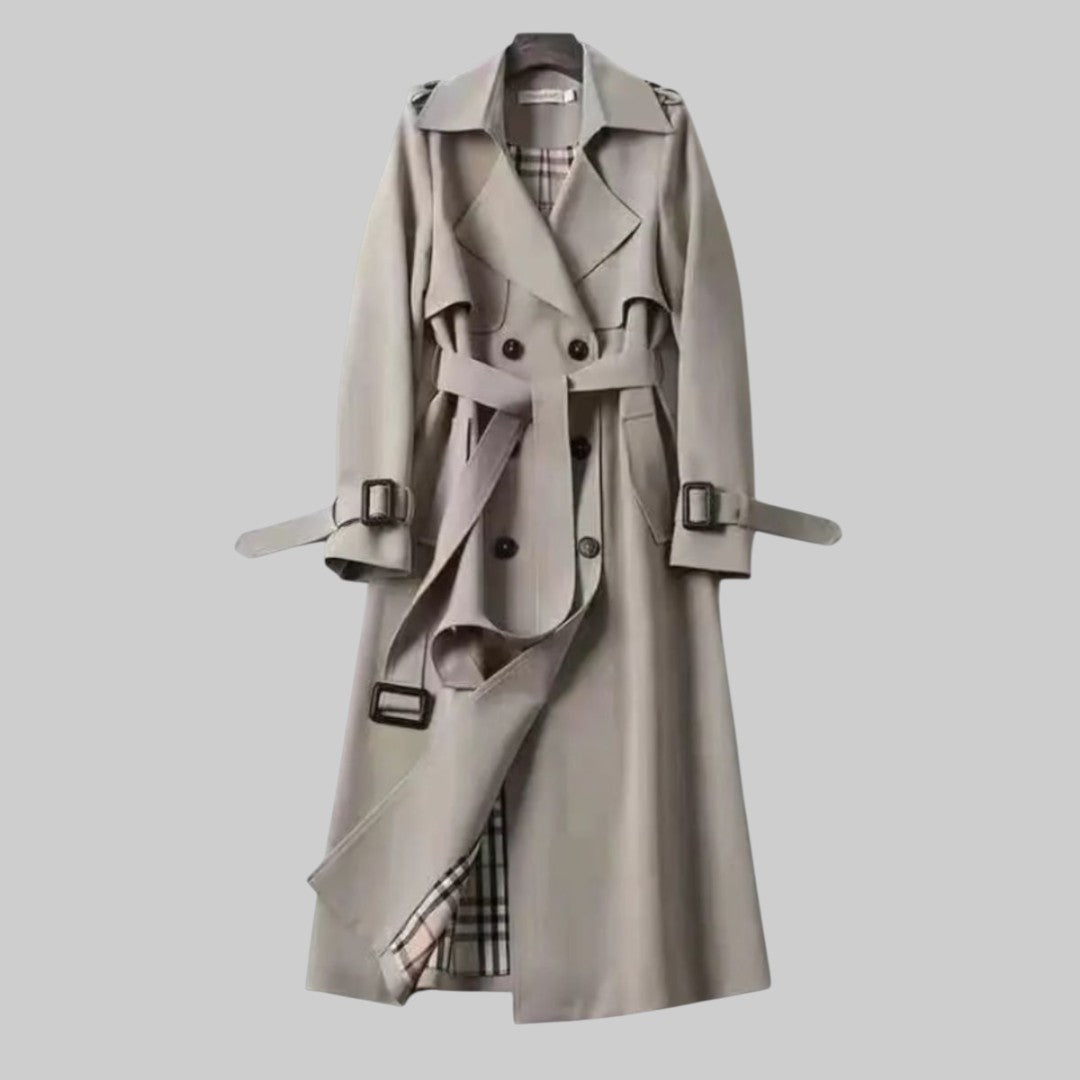 Women's belted double-breasted trench coat by Emily Carter, stylish and classic in beige fabric, shown on a model.