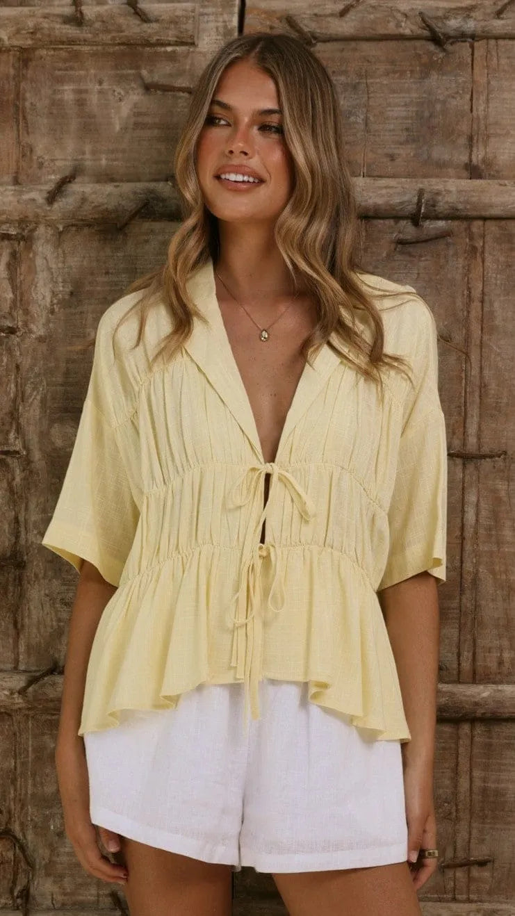 Homixa women's tie-front short-sleeve peplum blouse with V-neck and ruffled hem, shown in a stylish, casual fit.