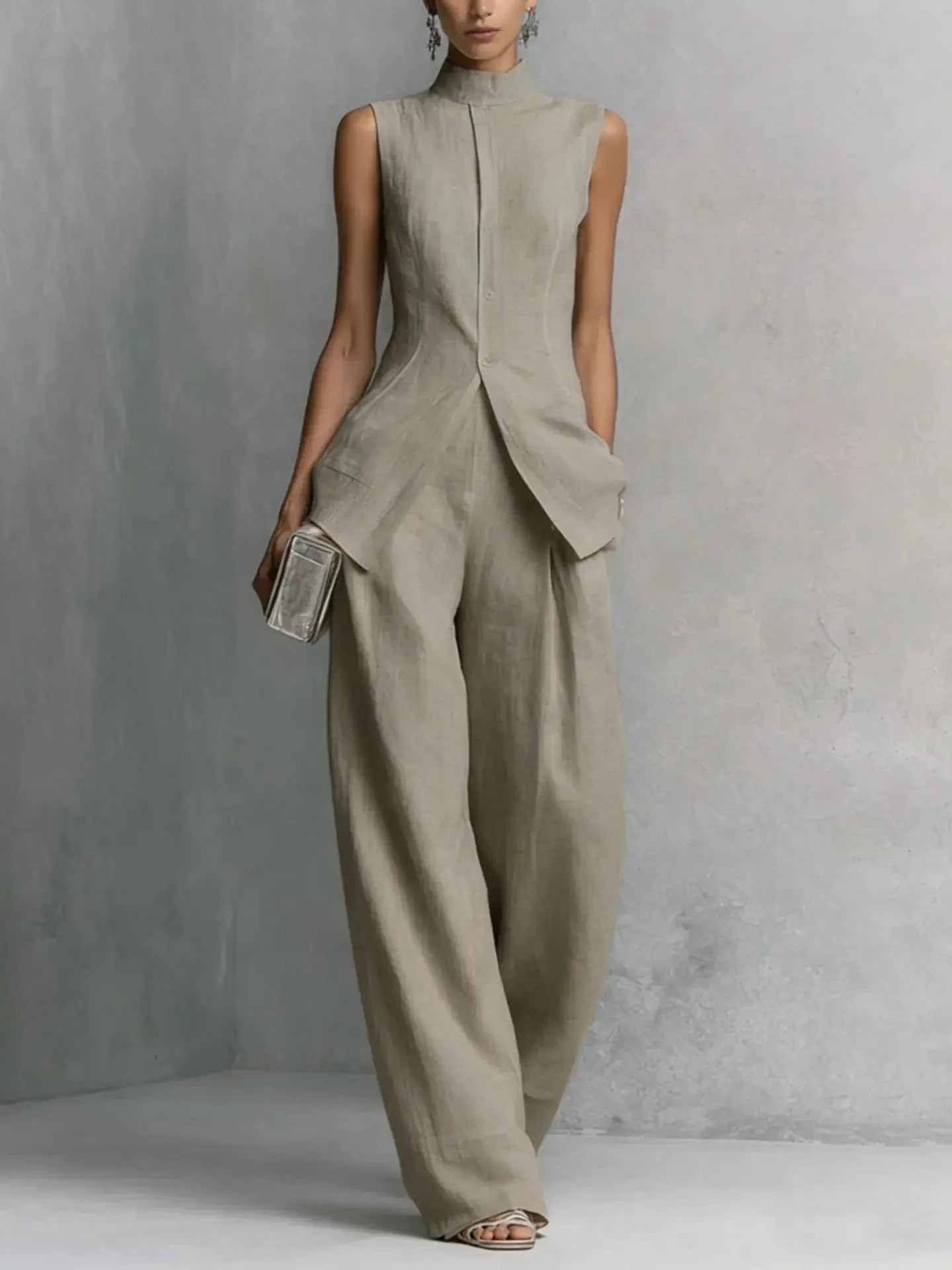 Women's sleeveless stand-collar peplum pant set by Homixa, featuring a stylish two-piece design with a fitted top and matching pants.
