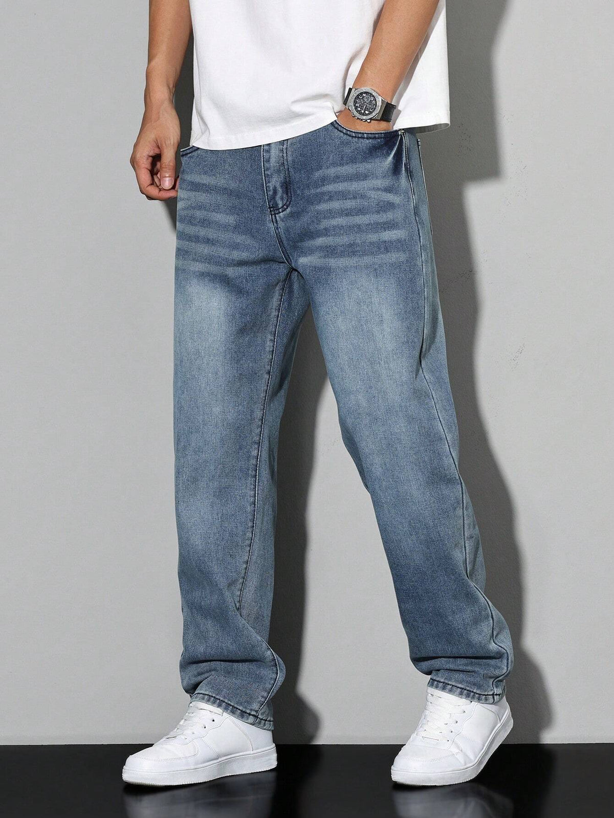 Men's baggy denim jeans by Kate and Wendy featuring a zip fly and five-pocket design, displayed on a model.