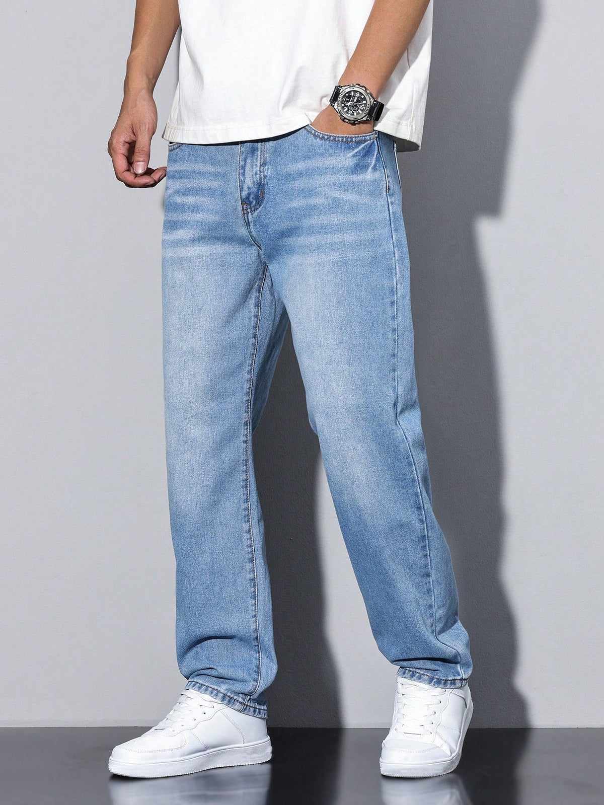 Men's baggy denim jeans with zip fly and five pockets by Kate and Wendy, shown on a model.