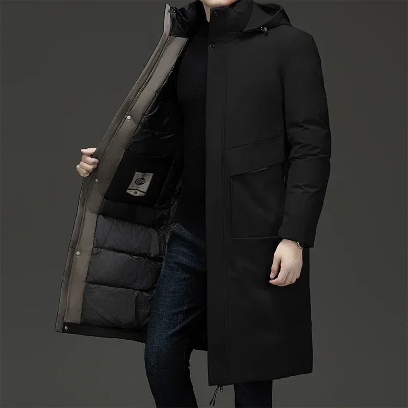 Men's long puffer coat by Homixa with quilted lining and adjustable drawstring hood, designed for warmth and style.