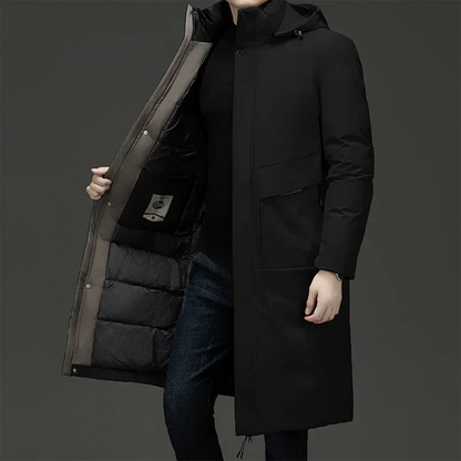 Men's long puffer coat by Homixa with quilted lining and adjustable drawstring hood, designed for warmth and style.