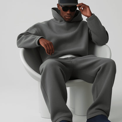 Men's oversized fleece tracksuit set by Homixa featuring a drawstring hoodie and elastic-waist joggers, laid flat.