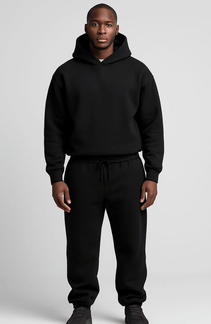 Men's oversized hoodie and jogger tracksuit set by Homixa featuring a drawstring hood and elastic waist for a casual, comfortable look.