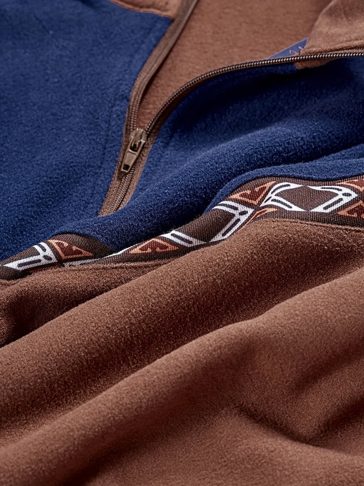 Men's Homixa quarter-zip sweater with color-block knit, geometric trim, and stand collar, showcasing stylish and cozy design.