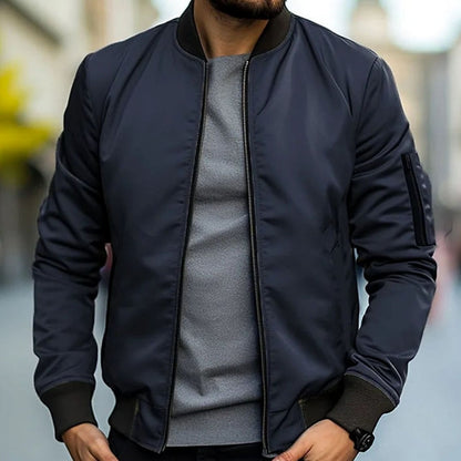 Men's short-cut bomber jacket by Homixa featuring a full zip, ribbed cuffs, collar, and hem, displayed on a hanger.