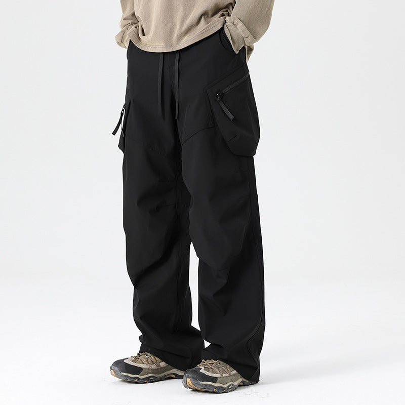 Men's wide-leg drawstring cargo trousers from Homixa with multiple utility pockets and a loose fit, shown on a model.