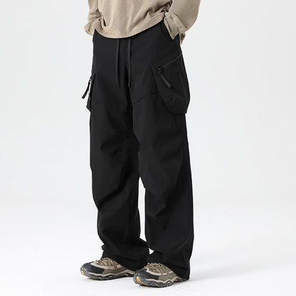Men's wide-leg drawstring cargo trousers from Homixa with multiple utility pockets and a loose fit, shown on a model.