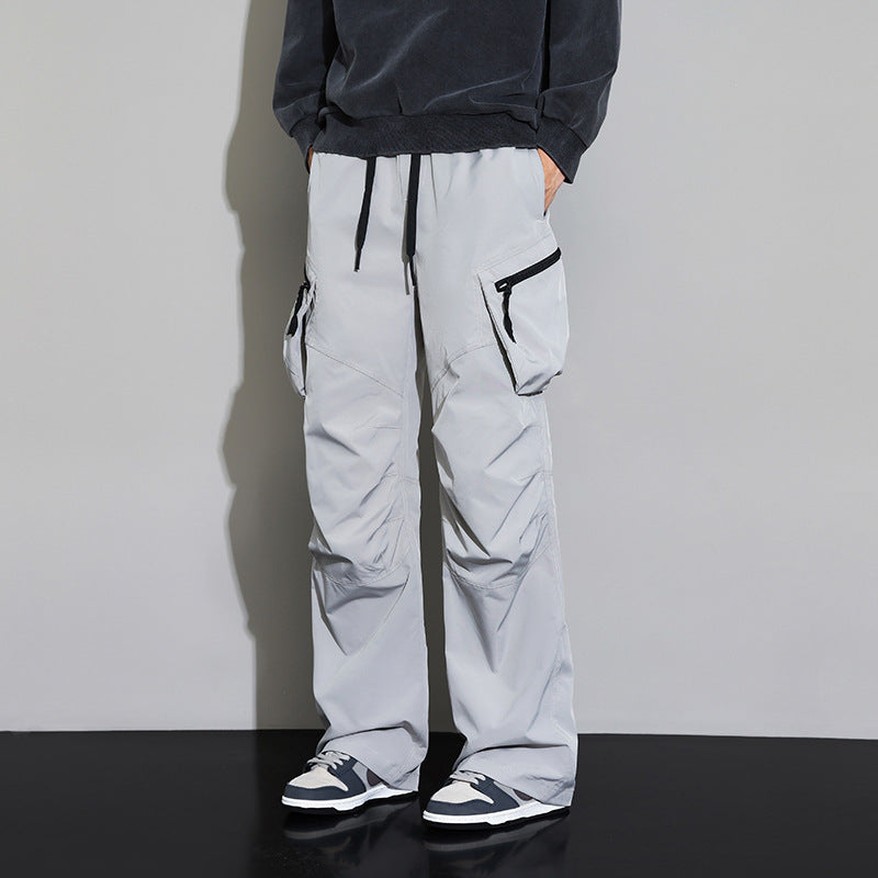 Men's wide-leg drawstring cargo pants by Homixa with multiple utility pockets and a loose fit, shown in a casual outdoor setting.