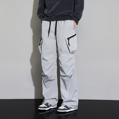 Men's wide-leg drawstring cargo pants by Homixa with multiple utility pockets and a loose fit, shown in a casual outdoor setting.