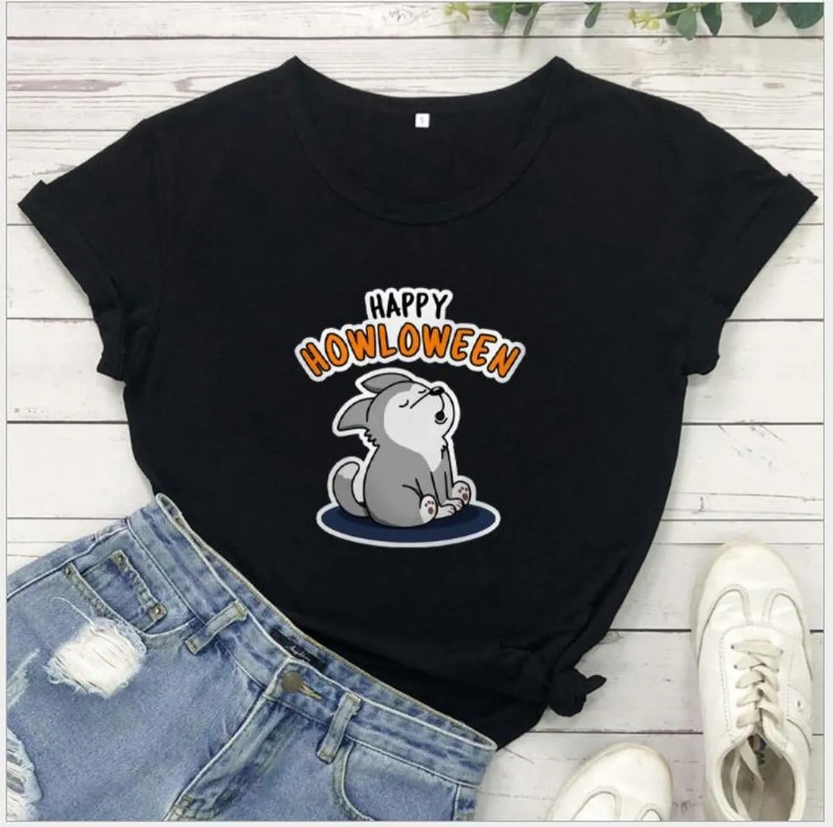 Women's Halloween T-Shirt by Homixa featuring a playful Happy Howloween graphic on soft cotton fabric.