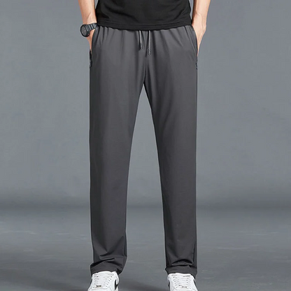 Men's Homixa quick-dry stretch hiking trousers with tapered legs, drawstring waist, and zip pockets, suitable for outdoor adventures.