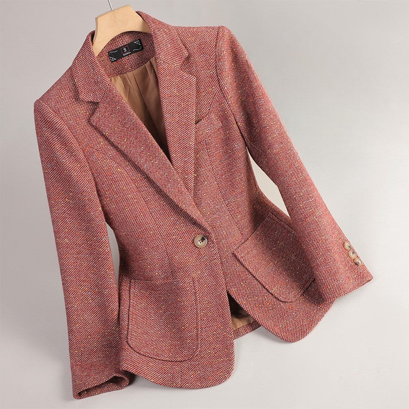 Red Margot Wool Blazer by Jack Hafford hanging on a wooden hanger against a plain background.