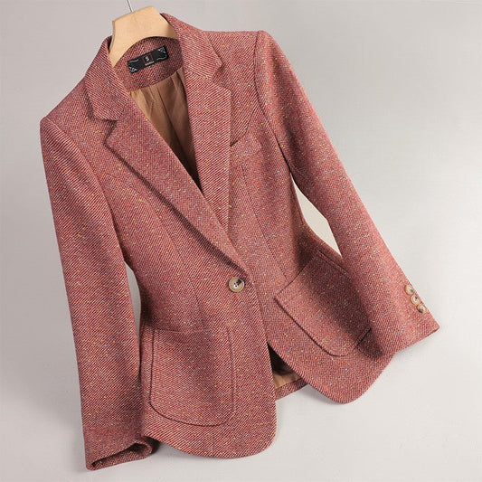Red Margot Wool Blazer by Jack Hafford hanging on a wooden hanger against a plain background.