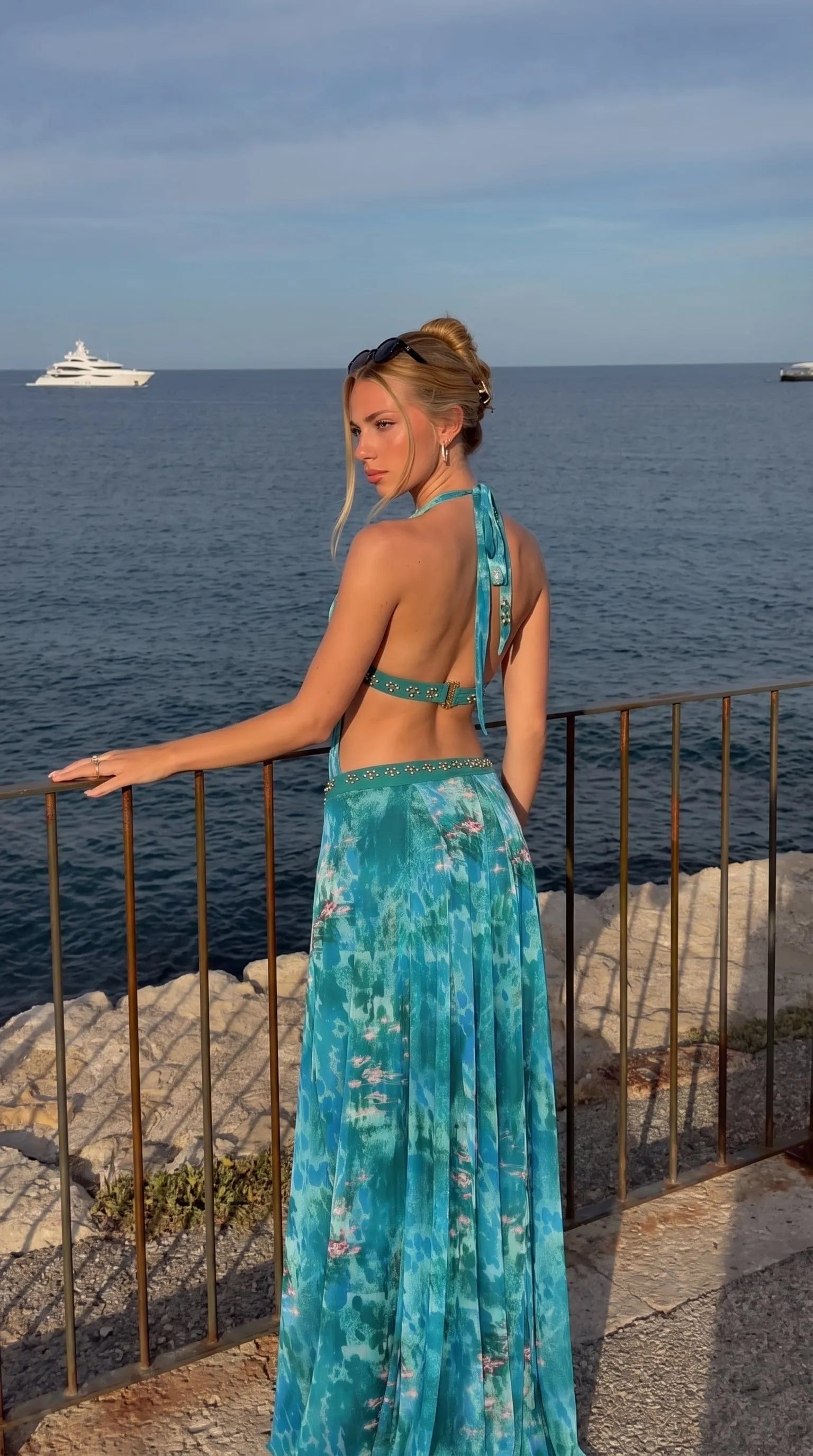 Homixa Women's printed halter-neck maxi dress with floral pattern, flowing fabric, and sleeveless design for elegant summer wear.