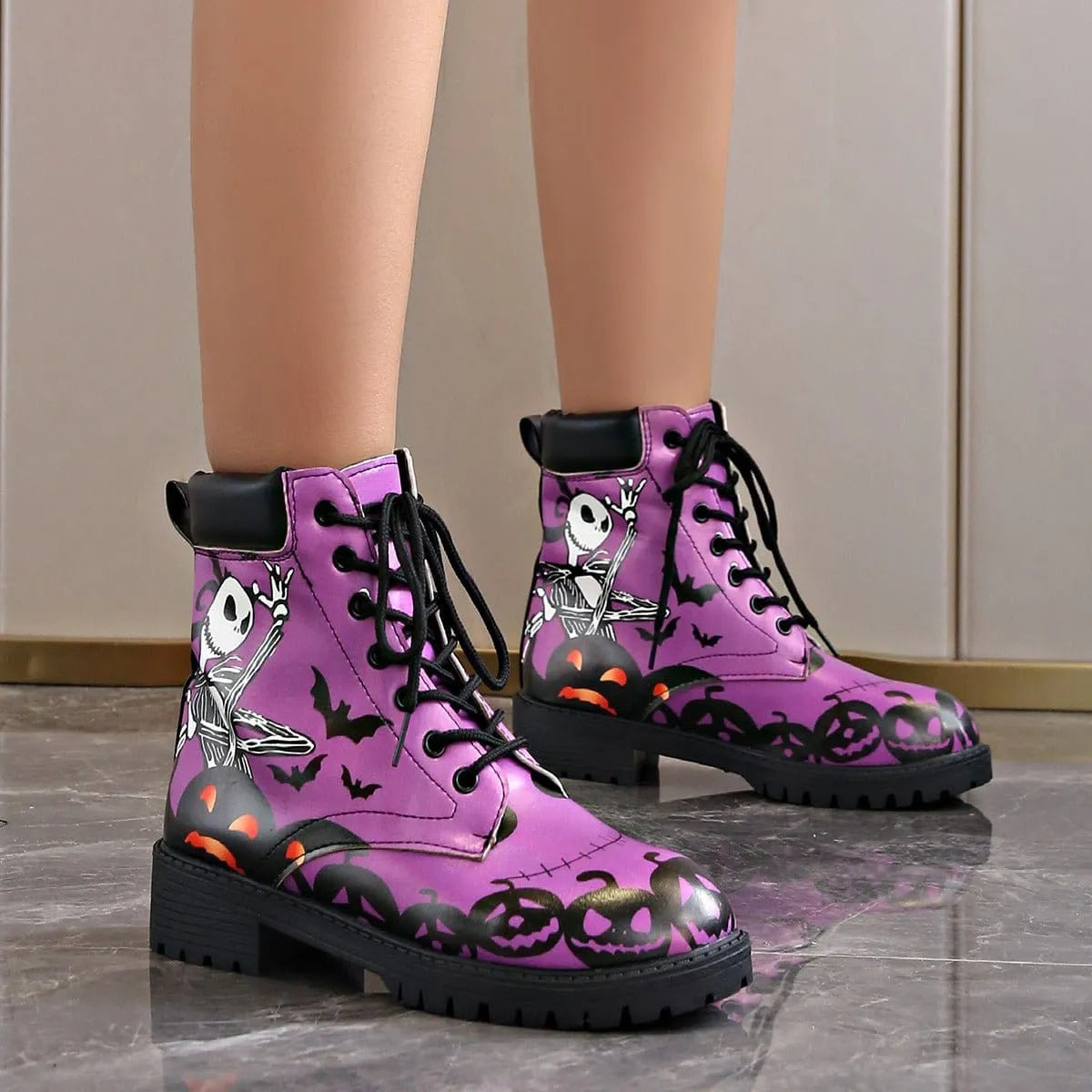 Women's Halloween combat boots by Homixa featuring a skeleton, pumpkin, and bat lace-up design with spooky details.