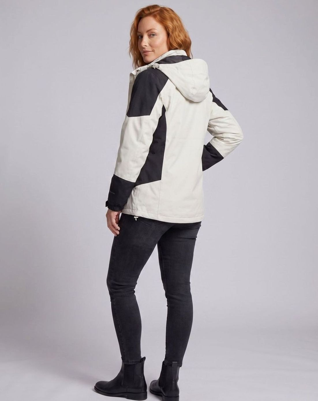 Homixa waterproof two-layer hooded outdoor jacket with adjustable hem and cuffs, shown on a mannequin in outdoor setting