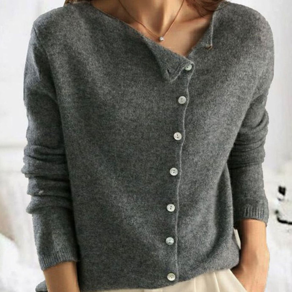 Women's asymmetric V-neck cardigan by Homixa with soft knit fabric and pearl-tone buttons, featuring a button-front design.