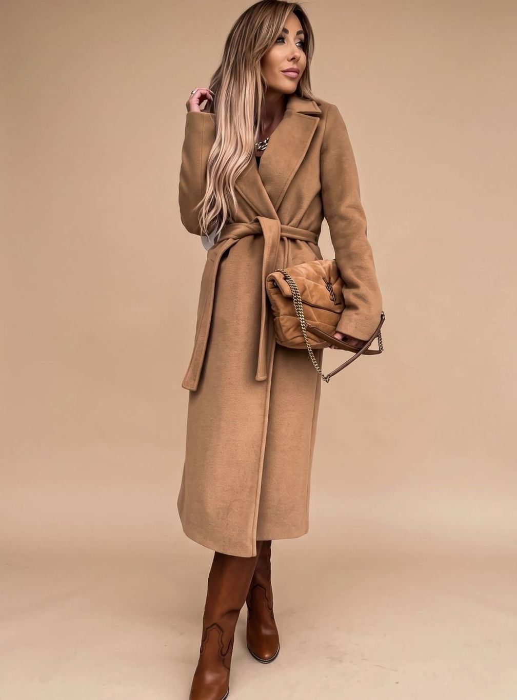 Women's belted knee-length trench coat by Homixa featuring notched lapels and wool-blend fabric, shown hanging on a hanger.