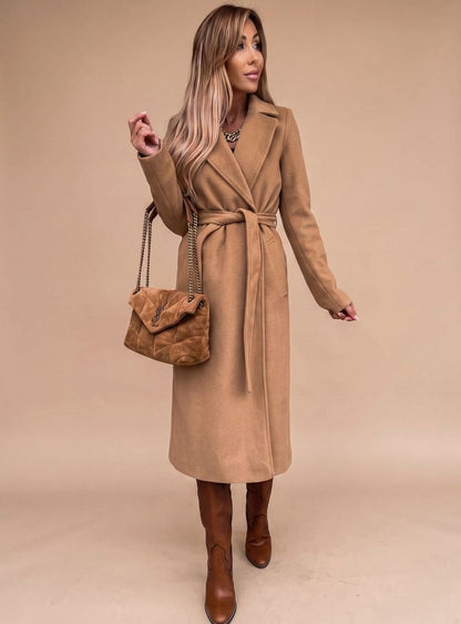 Women’s belted knee-length trench coat with notched lapels and wool-blend fabric, featuring a waist belt and classic style.