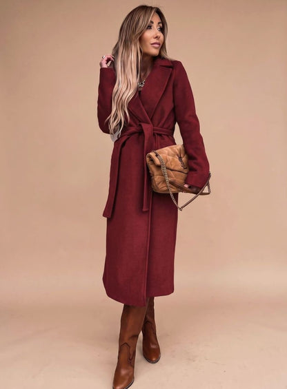 Women's belted knee-length trench coat with notched lapels and wool-blend fabric, featuring a classic silhouette and stylish belt detail.