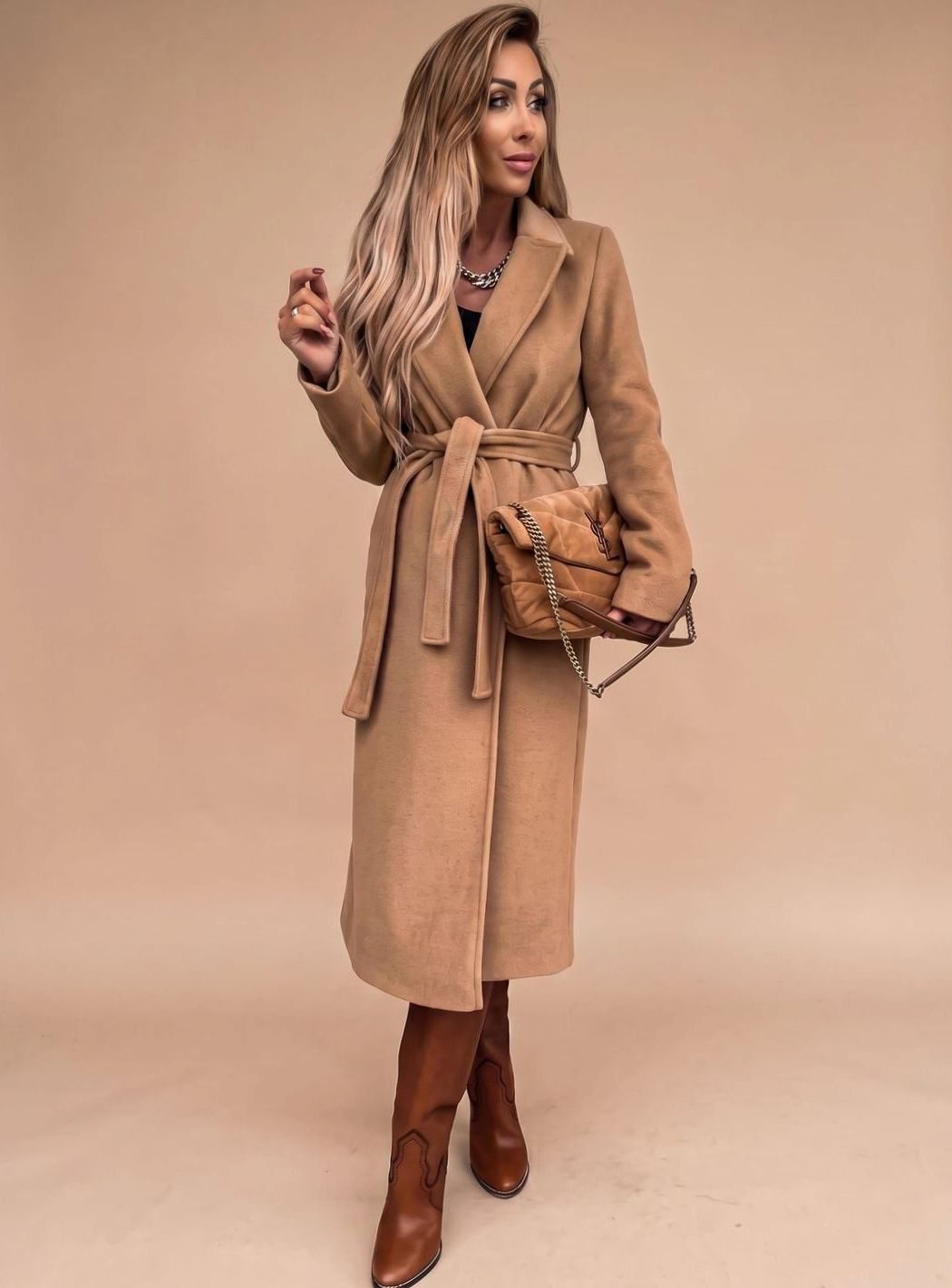 Women's belted knee-length trench coat by Homixa featuring notched lapels and wool-blend fabric, displayed hanging on a coat rack.