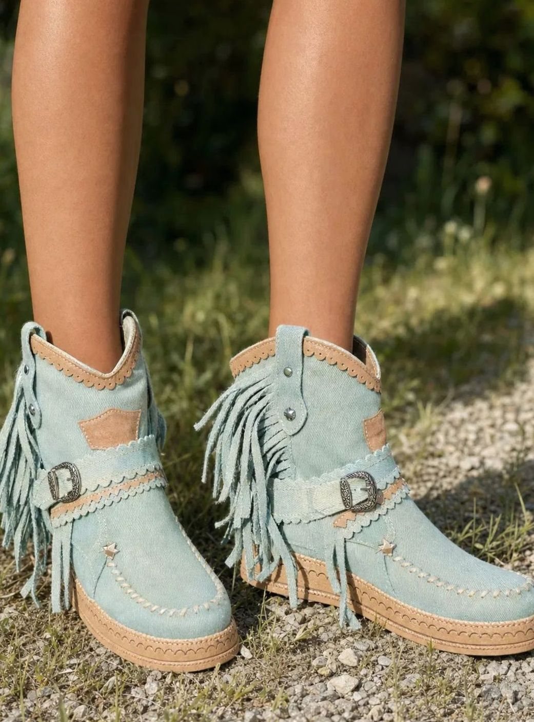 Women's boho western boots by Homixa featuring fringe, buckle details, and decorative stitching on leather ankle booties.
