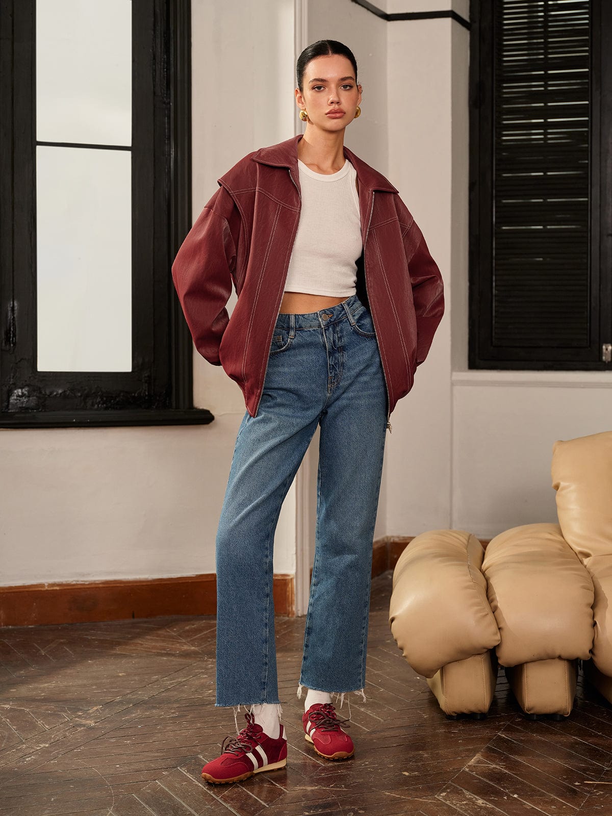 Women's burgundy vegan-leather jacket by Homixa with a zip-front, clean lines, and sporty accents, shown on a model.