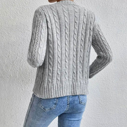 Women's cable-knit cardigan by Homixa with button front, long sleeves, and gold-tone buttons, shown in a cozy knit texture.
