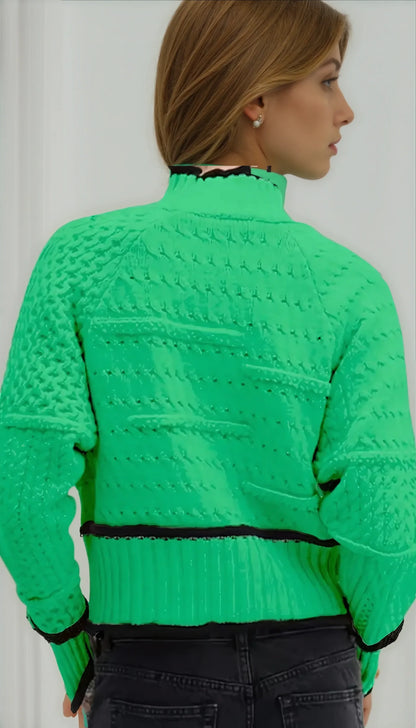 Women’s cable-knit sweater by Homixa featuring a geometric pattern with black contrast trim and cozy knit texture.