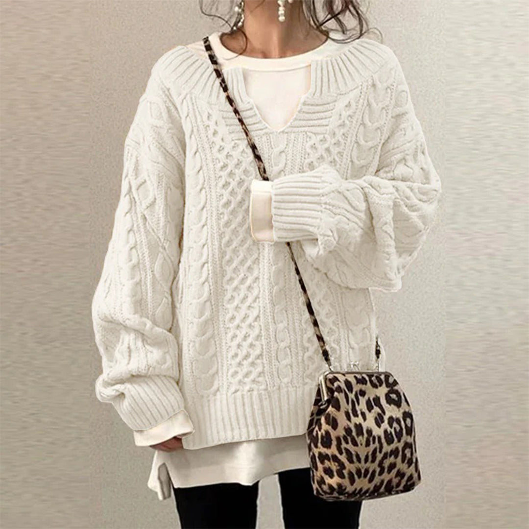 Women's cable-knit sweater by Homixa featuring a notched neckline and wide ribbed cuffs, styled for a cozy and fashionable look.