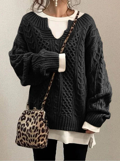 Women’s cable-knit sweater by Homixa featuring a notched neckline and wide ribbed cuffs, styled for a cozy, fashionable look.