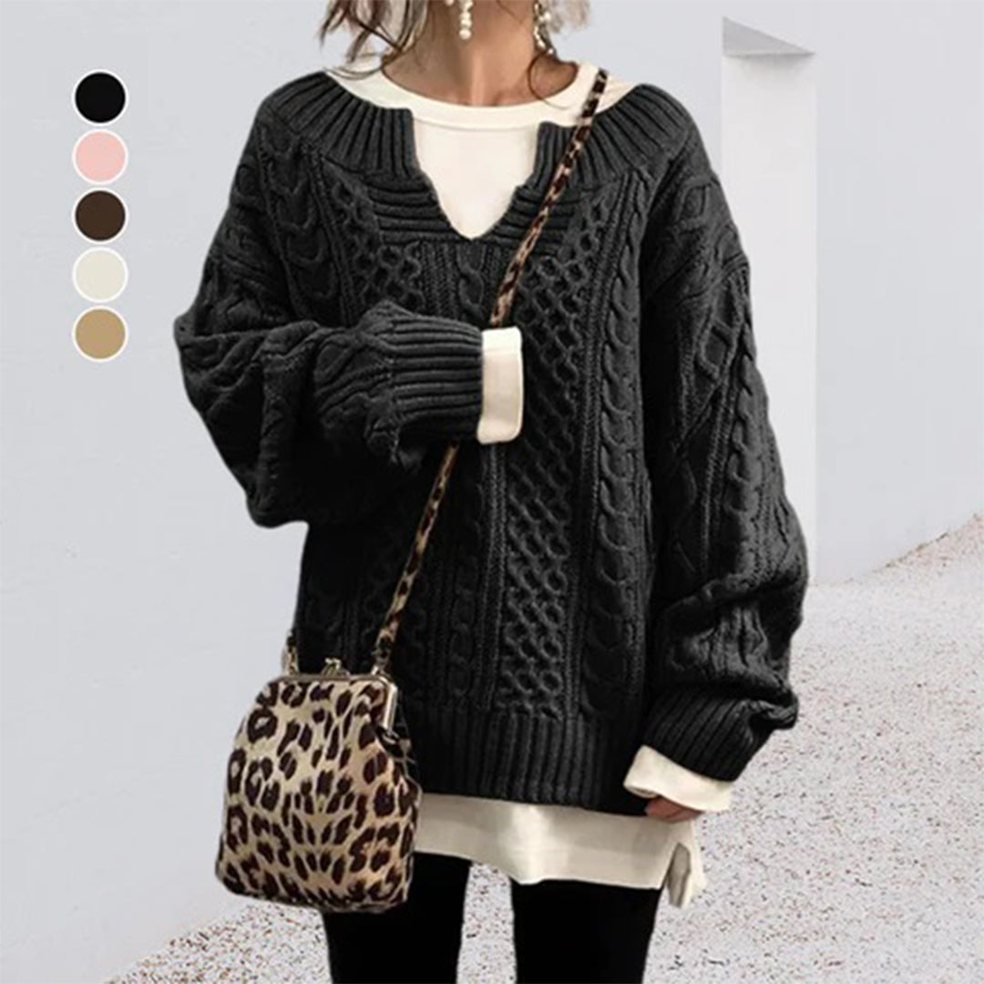 Woman wearing a Homixa cable-knit sweater with a notched neckline and wide ribbed cuffs, showing its cozy knit details.