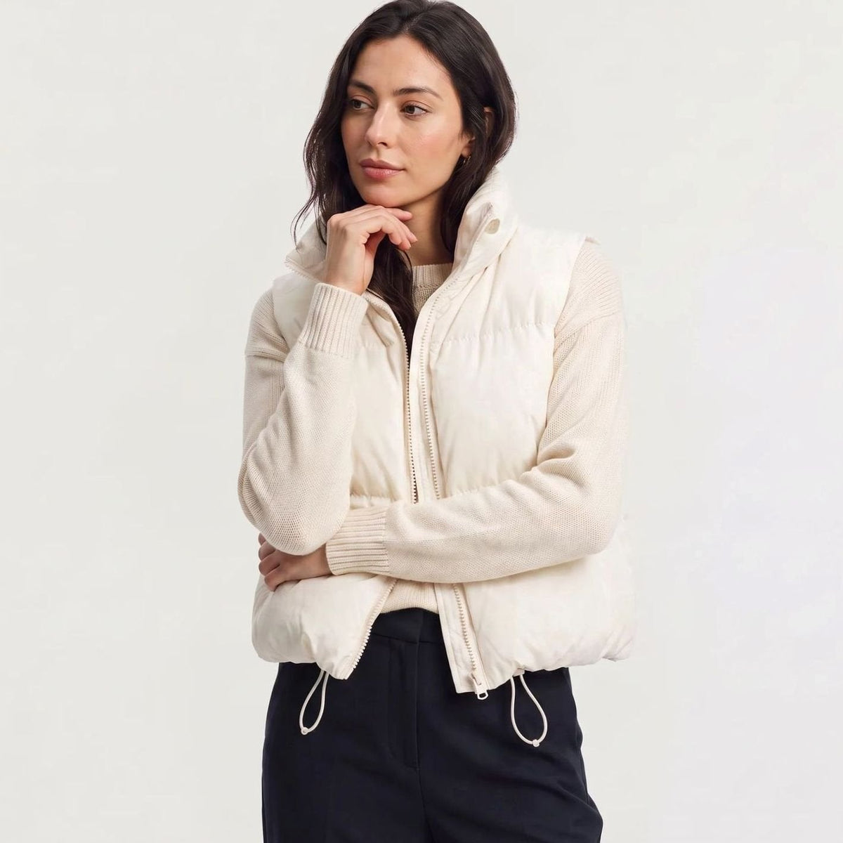 Women's white quilted sleeveless puffer vest with high collar and zip front, casual cropped style by Homixa.
