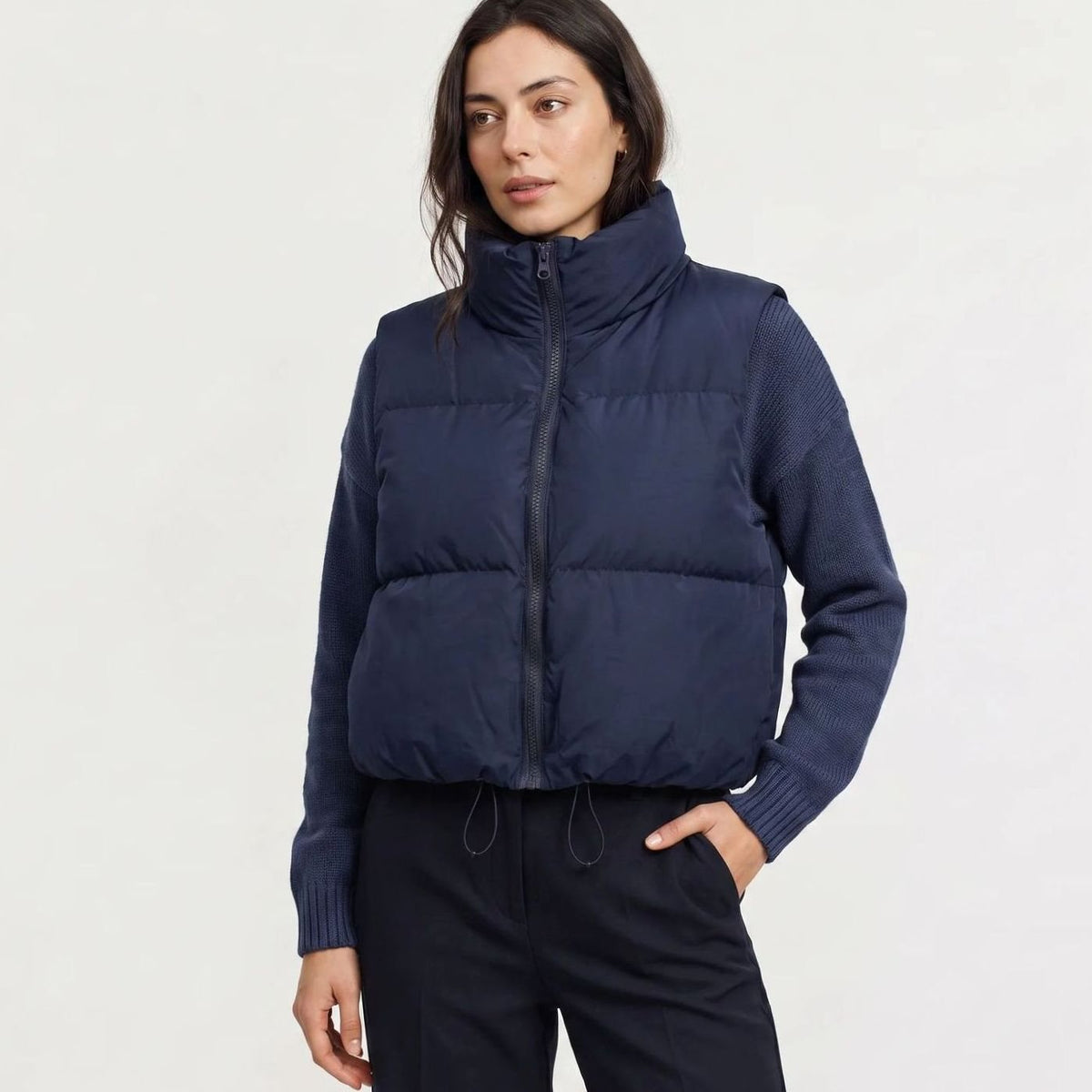 Women's casual cropped quilted puffer vest with high collar and zip-front closure, sleeveless design by Homixa.