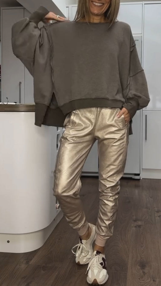 Women's oversized casual two-piece set by Homixa featuring a cozy sweater and satin pants, displayed on a model.