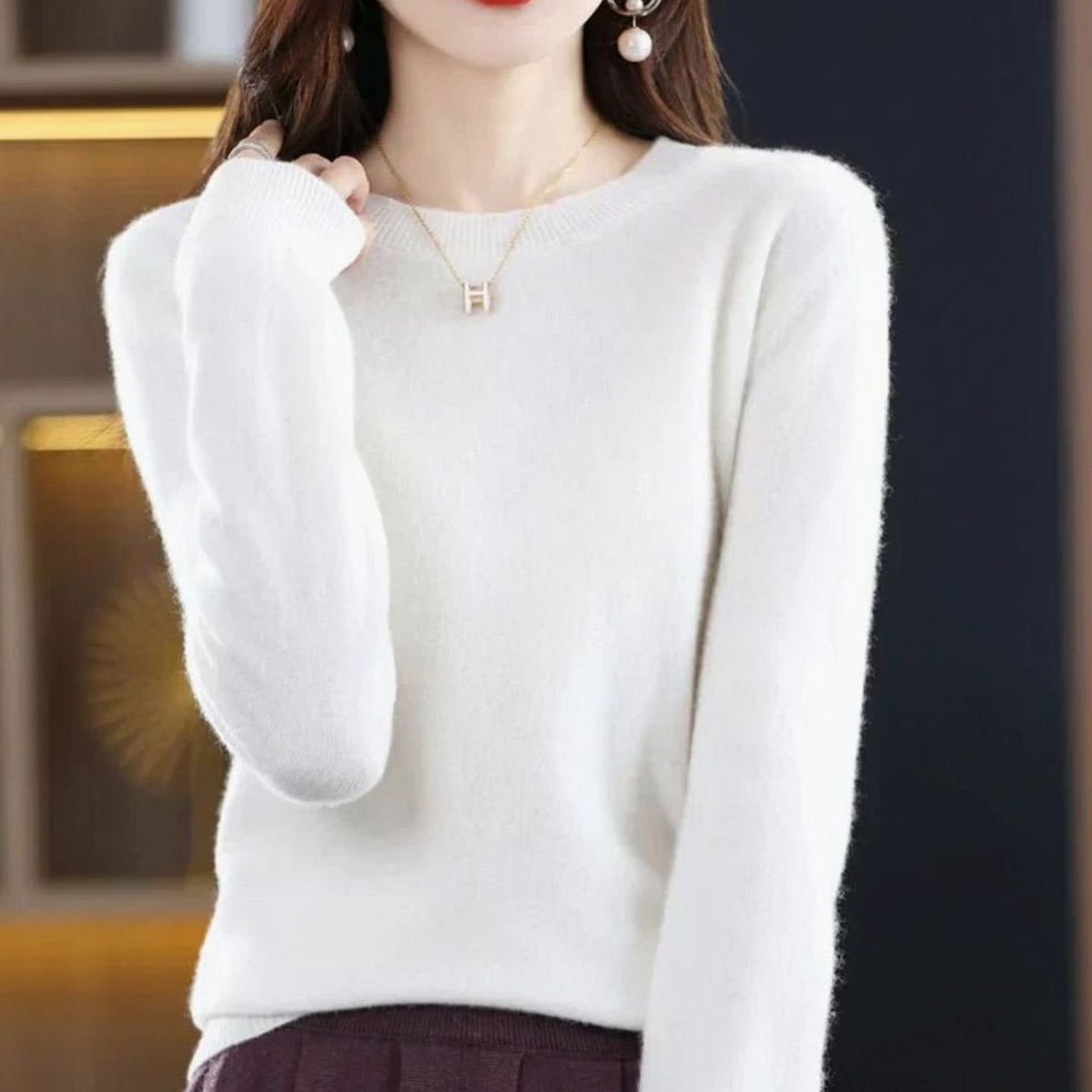 Women’s classic long-sleeve crew-neck knit sweater by Homixa with a soft, cashmere-like feel, styled on a model.