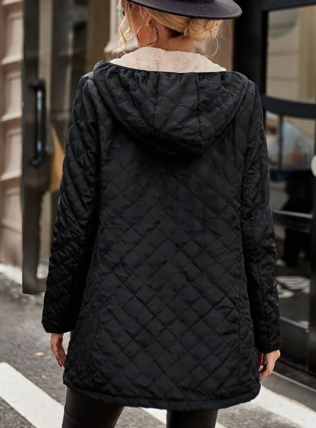 Women's mid-length quilted puffer winter jacket by Homixa with fleece lining, designed for warmth and comfort in cold weather.