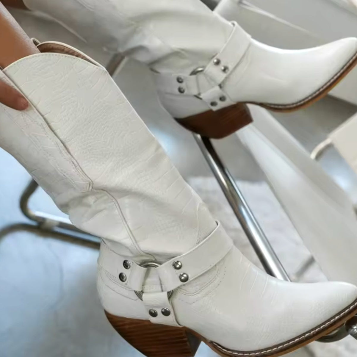 Women's cow-print knee-high western boots by Homixa featuring pointed toe, block heel, and harness buckles.