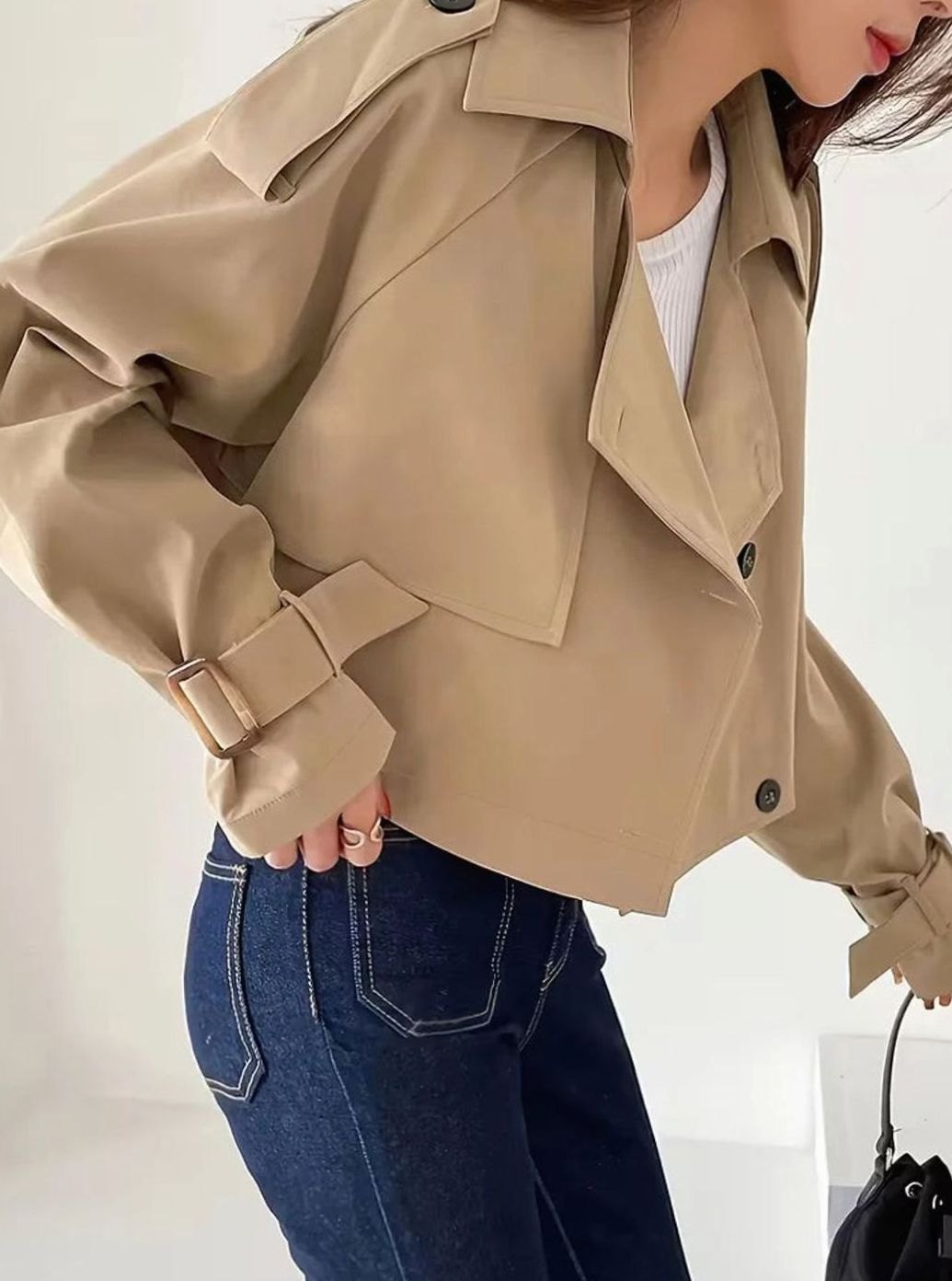 Women's cropped double-breasted trench coat by Homixa with lapels and adjustable cuffs, styled for a sophisticated look.