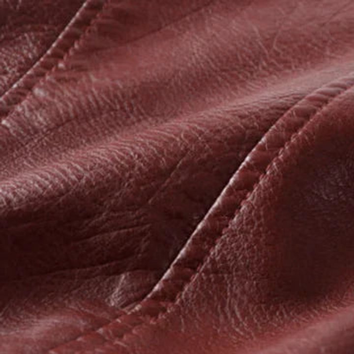 Women's cropped faux-leather biker jacket by Homixa featuring an asymmetric zip, belted waist, and classic moto style.