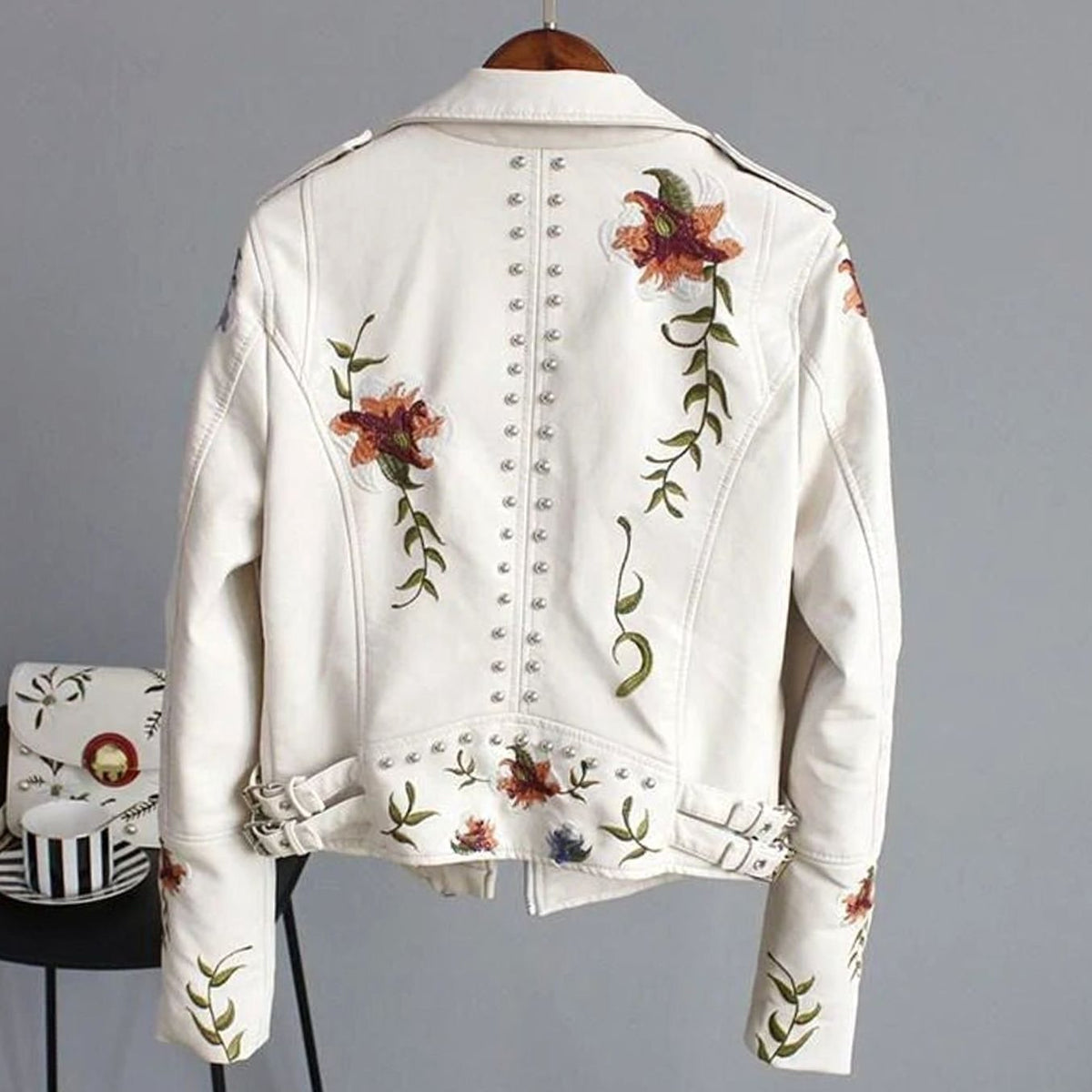 Women's faux-leather moto jacket by Homixa featuring floral embroidery and metal studs, cropped biker style with stylish detailing.
