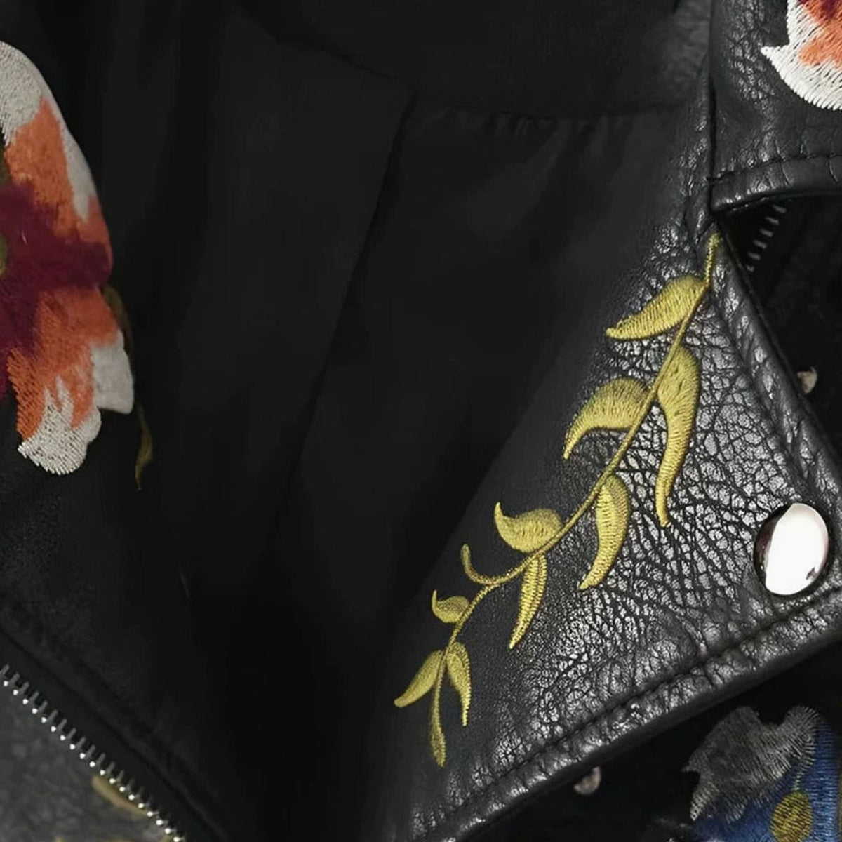 Women's cropped faux-leather moto jacket by Homixa with floral embroidery and metal studs, featuring a stylish biker jacket design.