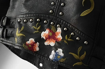 Women's faux-leather moto jacket by Homixa featuring floral embroidery and metal studs, cropped biker style, stylish and edgy.