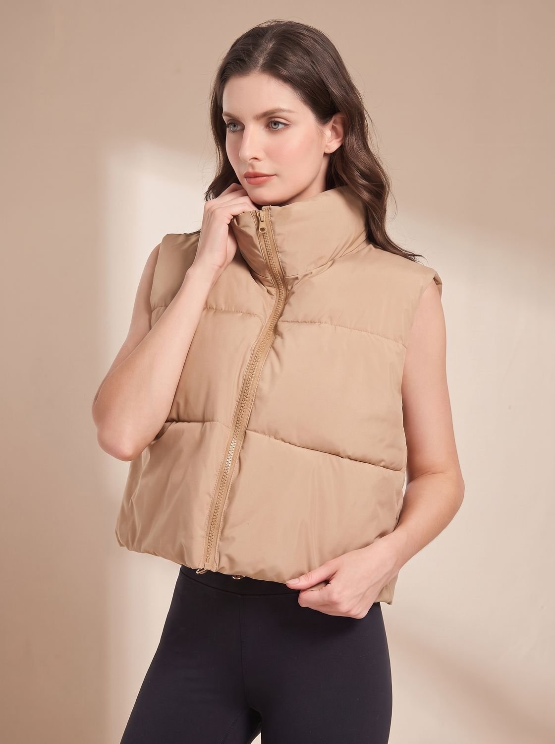 Women's lightweight cropped puffer vest by Homixa with stand collar and two-way zipper, perfect for layered winter style.