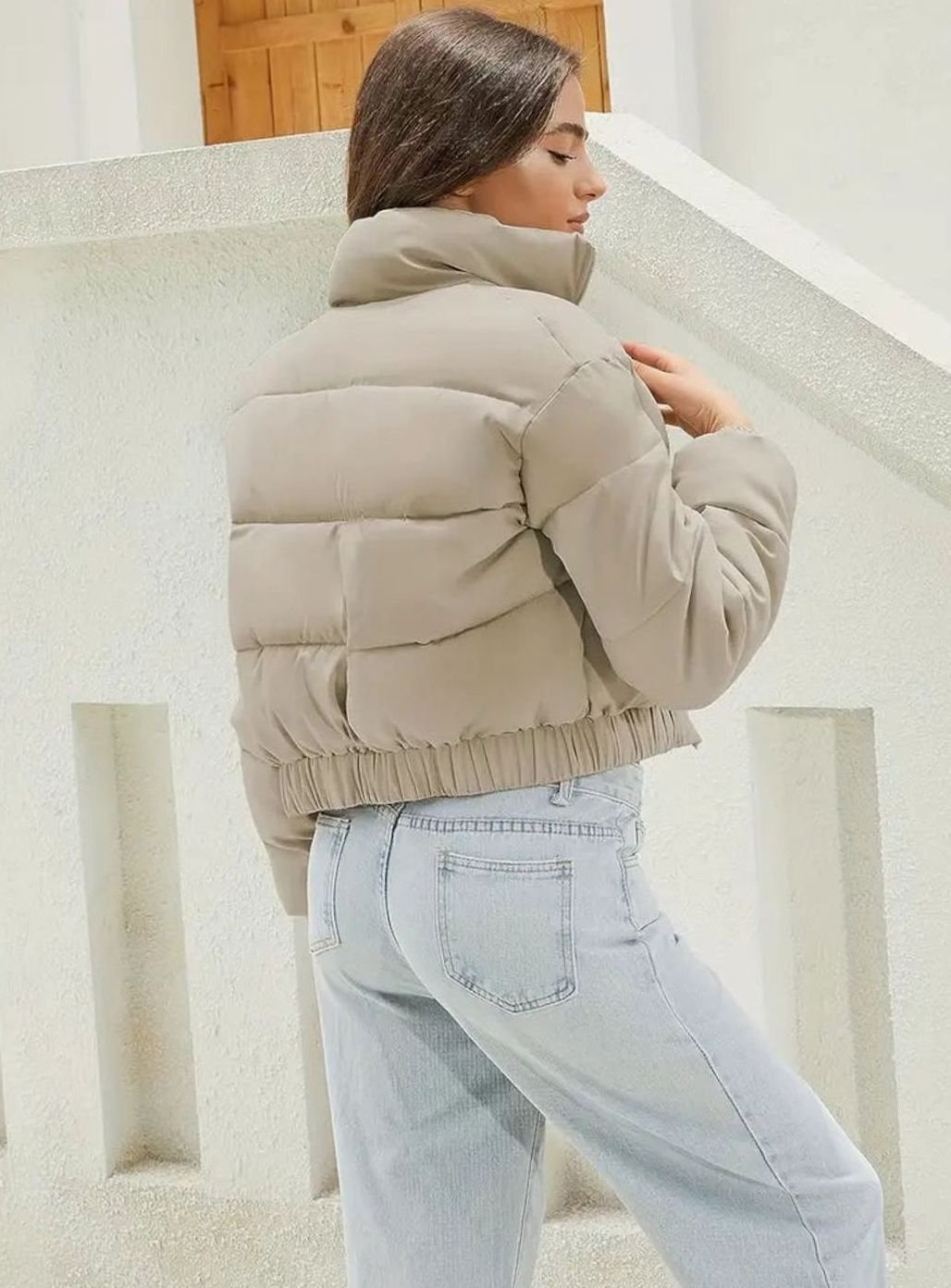 Women's Homixa cropped puffer jacket with stand collar, zip front, and elastic cuffs displayed on a model.