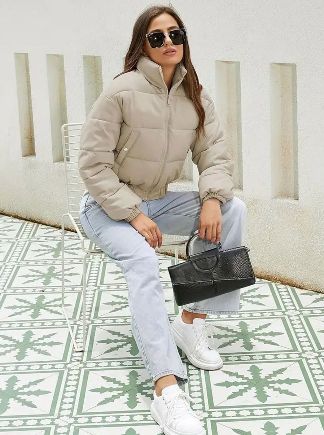 Women's Homixa cropped puffer jacket with stand collar, zip front, and elastic cuffs, shown on a hanger.